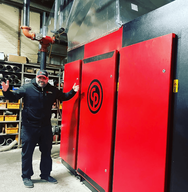 image of technician with Chicago Pneumatic industrial air compressor