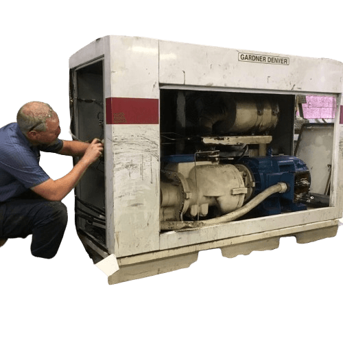 person doing an oil change on an air compressor